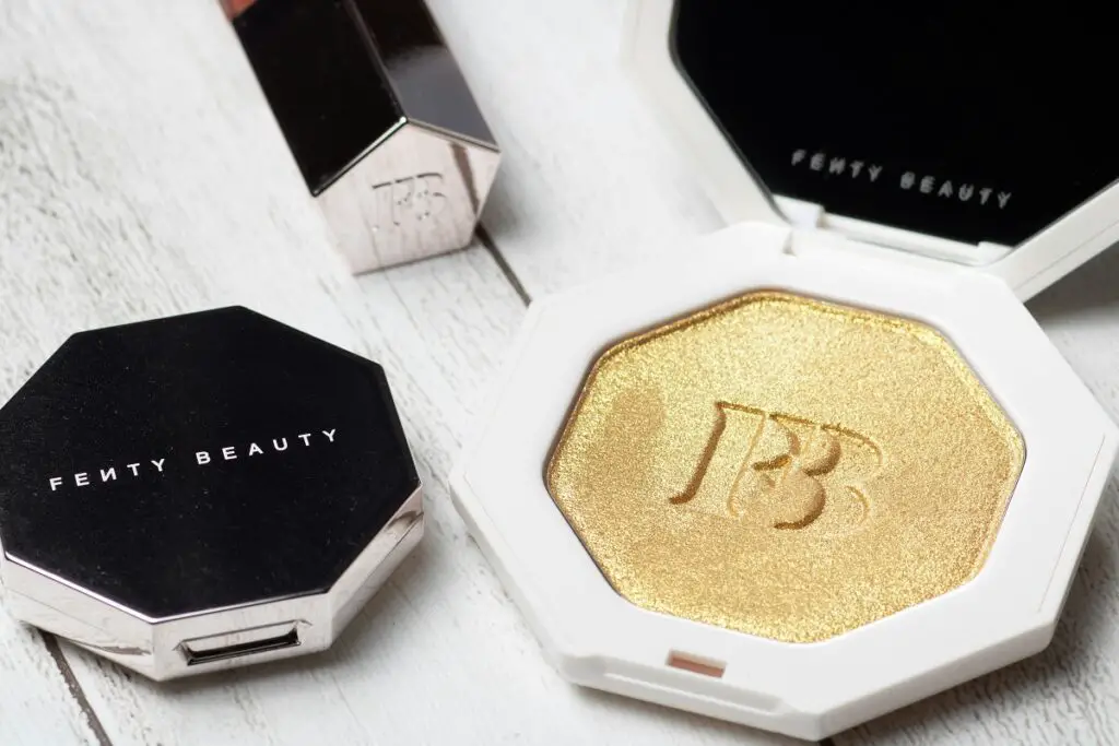 Fenty Beauty highlighter and makeup products