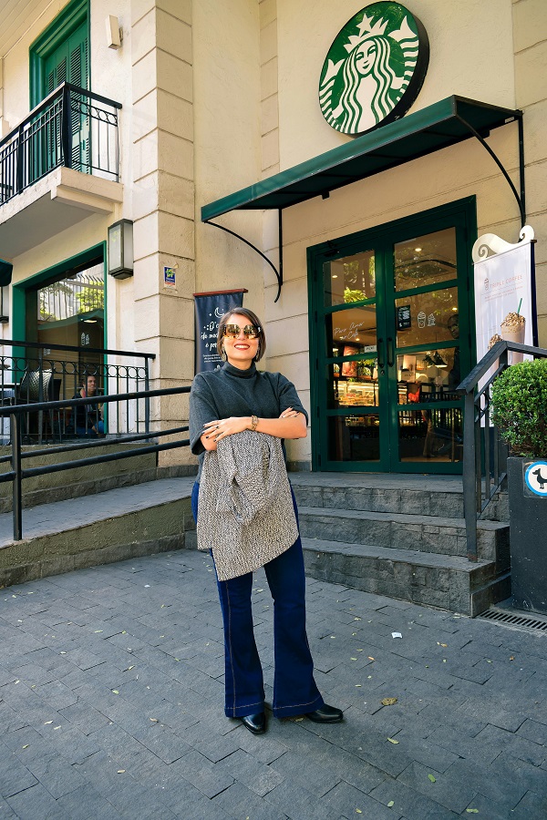 Photo of a Woman Standing Outside Starbucks
